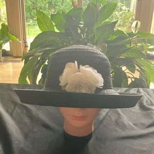 Elegant Black Hat with White Floral Accent